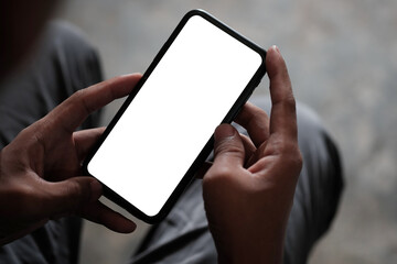 Over the shoulder view of man using smart phone. Blank screen for your information..