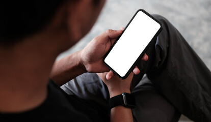 Close up view man using mobile phone in living room...