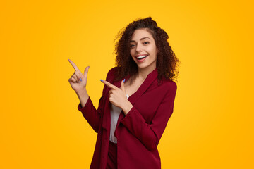 Businesswoman pointing away in studio