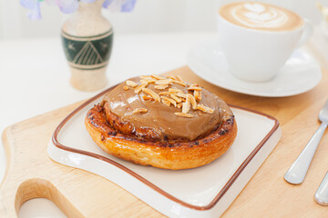 Coffee almond caramel cinnamon roll with hot latte