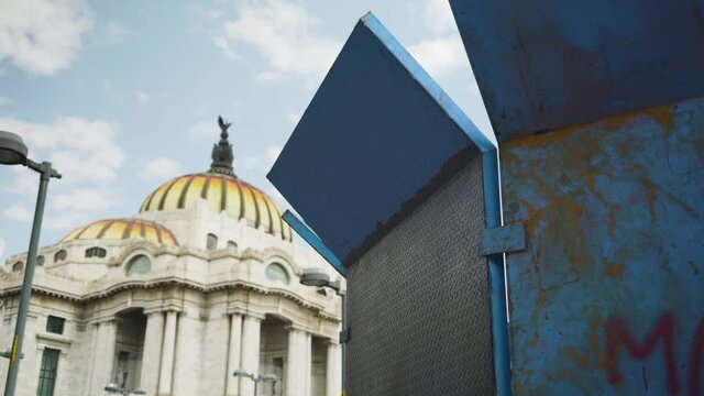 Mexico City prepares for public march and protest by erecting strong barriers to protect buildings monuments. Palacio de Bellas Artes, Palace of fine arts in background
