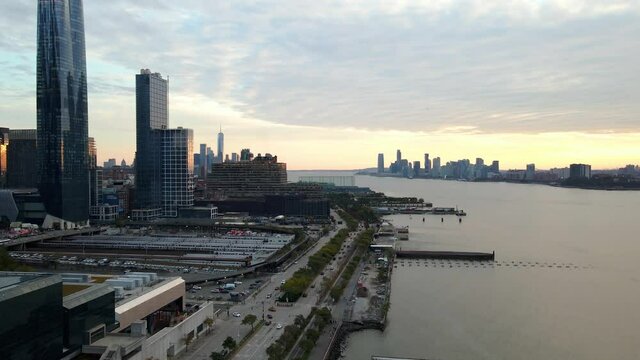 Aerial drone view overlooking traffic on the 12th Ave, dusk in Hudson yards, NYC