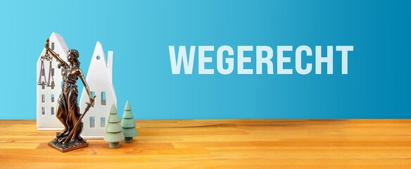 Wegerecht. Justita Statue mit Häusern und Bäumen auf Tisch vor blauen Hintergrund.
