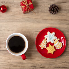 Merry Christmas with homemade cookies and coffee cup on wood table background. Xmas eve, party, holiday and happy New Year concept