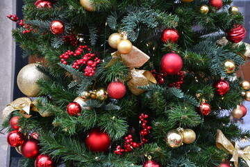 Christmas tree branches close, toy berries and balls close