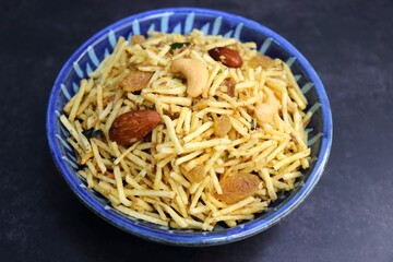 Fried potato falahari chivda, Aloo chiwda is also known as a Fasting snack. Prepared using potatoes, dry fruits and mild spices for Navaratri or any vrat or upwas. Served in a wooden bowl. Copy Space.
