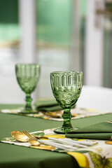 Dinner table setting idea with textured green glass goblets.