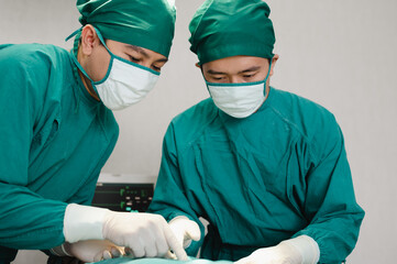 Team of doctors wearing protective clothing works together to monitor patients in Bright Modern operating room. Surgery on patients lying on patient beds. resuscitation of the wounded.