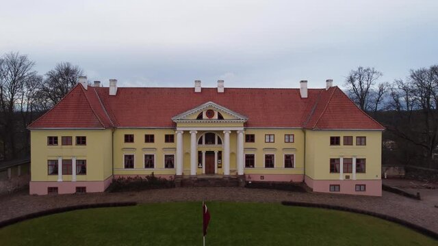 Fly over from the fornt of the Durbe manor castle, areal outumn view, Tukums, Latvia.