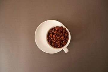 A Cup of Coffee, Coffee beans closed up. Coffee beans, Coffee beans and cup and saucer on brawn background. Cafe, Coffee, restaurant design elements.