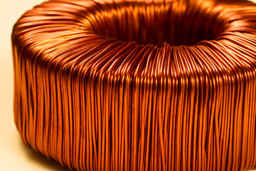 Copper wire in bright saturated color close-up. Toroidal transformer winding.