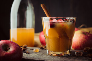 Traditional hot apple cider. Christmas drink with apples cinnamon, cranberry and anise. Homemade apple cider. Selective focus. Shallow depth of field.