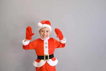 a little boy in a santa costume