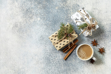 Сup of coffee and xmas gifts on a gray stone tabletop. New year or christmas concept. Top view flat lay.