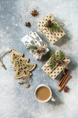 Сup of coffee and xmas gifts on a gray stone tabletop. New year or christmas concept. Top view flat lay.
