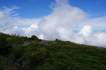 Fototapeta na wymiar clouds over the mountains, the highway and the sea on the tropical island of la réunion france