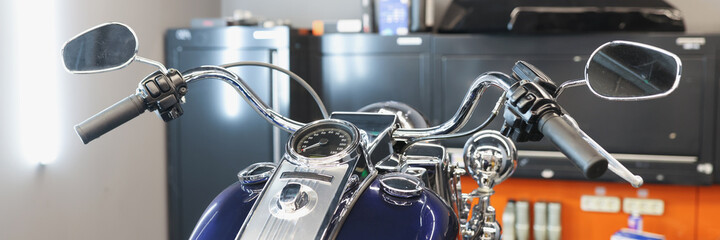 Front of motorcycle at service station closeup