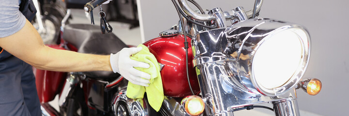 Man cleaning motorcycle in service center closeup © megaflopp