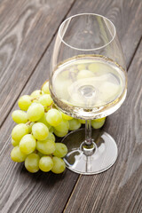 White wine glass and grape