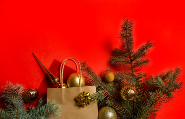 christmas toys and Christmas tree branches on a red background