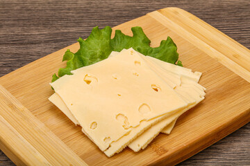 Sliced yellow cheese over board