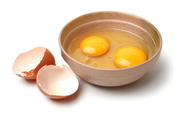 Wire whisk and brown eggs on white background 