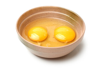 Wire whisk and brown eggs on white background 