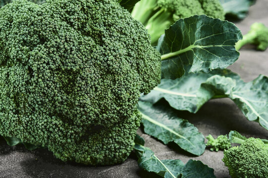 Fresh green broccoli, bright on a gray background. Close-up, selective focus. Healthy food, green fresh vegetables