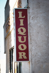 Old worn urban liquor store sign
