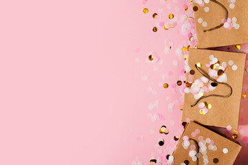 Valentine and mothers day concept with craft package with pink bow and confetti