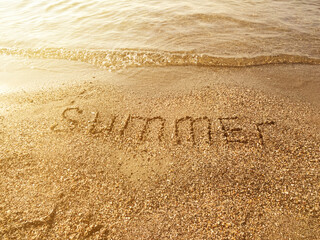 The word - Summer is written on the beach