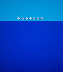 Covid-19 new variant - Omicron text on blue background