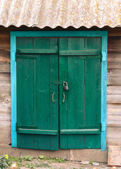 closed shed door under the roof , padlock