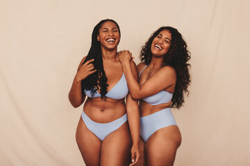 Friends celebrating their natural bodies in a studio