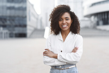 Young businesswoman in a city looking at camera, African american student girl portrait, Young...