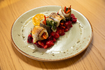 Fish fillet served with beetroot mashed potato and vegetables