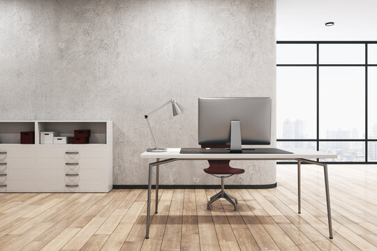 Contemporary concrete office interior with desktop and computer, other pieces of furniture and objects, window with city view and wooden flooring. 3D Rendering.