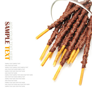 Breadsticks covered with chocolate on white background 