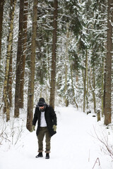 Bearded man in the winter woods. Attractive happy young man with beard walk in the park.