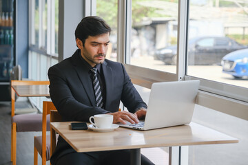 business caucasian man sitting in working in co working space
