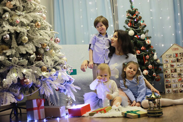 New Years Eve. The house is decorated for the holiday. Christmas tree with a garland and a family with gifts and a surprise.