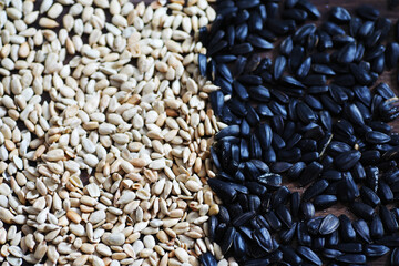 Sunflower seeds in a wooden spoon on a wooden rustic background.