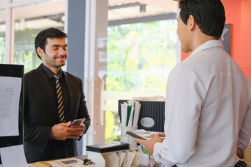 asia waiter serving caucasian businessman in cafe or restaurant