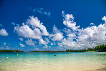 Tropical beach with tourists on a sunny day.