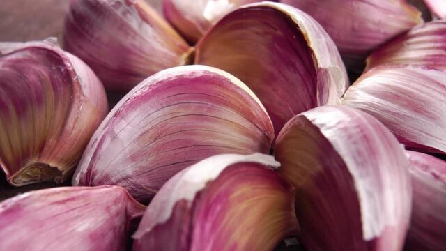 Delicious red garlic cloves. Macro. Rotation