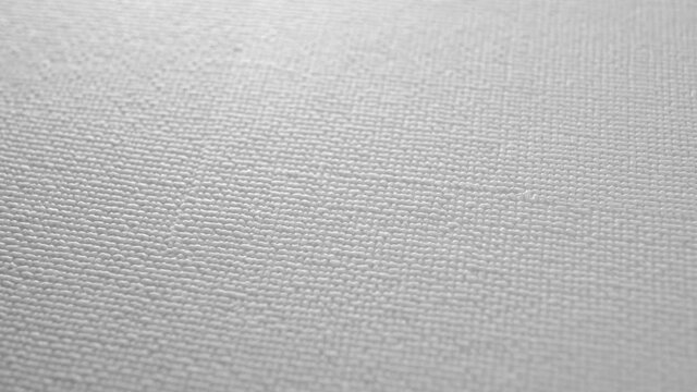 Geometric dots pattern on a plastic textured surface. Macro. Rotation