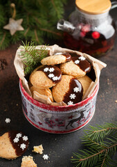christmas cookies with chocolate in a tin can on a christmas table