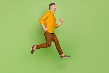 Full body profile side photo of mature man run energetic discount isolated over green color background