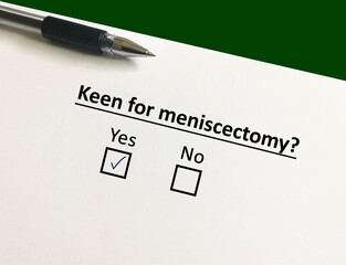 Fototapeta premium One person is answering question about surgery. The person is keen for meniscectomy.