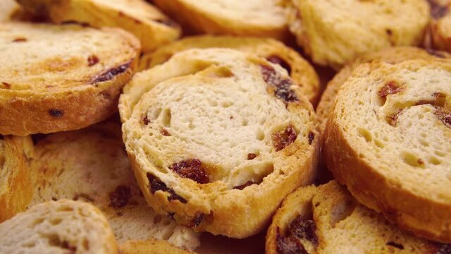 Pile of baked rusks with raisins. Macro. Rotation